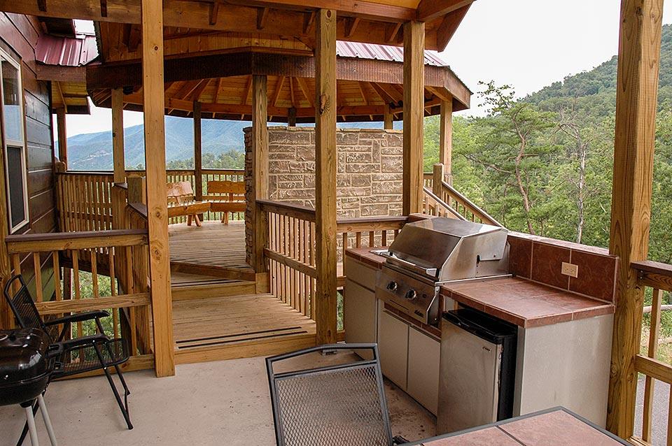 Outdoor kitchen and gazebo lounge deck for outdoor living at this cabin.